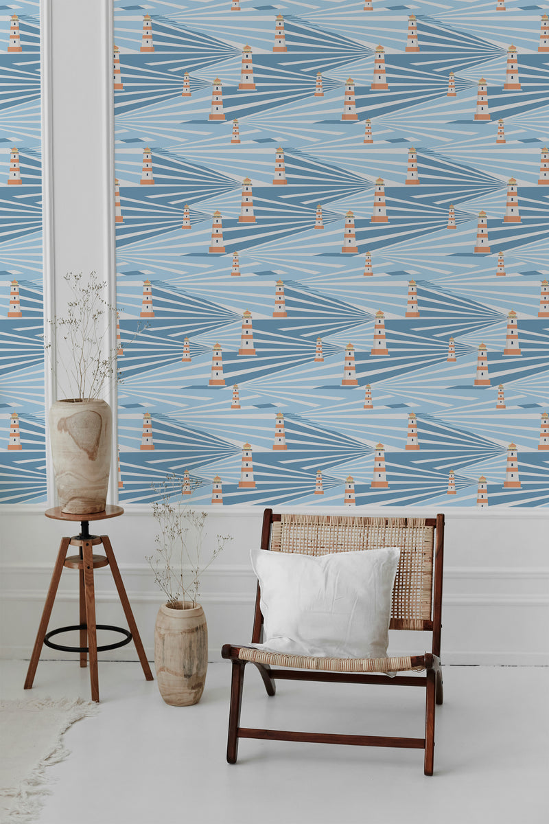 Lighthouse-themed wallpaper with a pattern of repetitive lighthouses in red and white colors across a blue and beige diagonal wave background, creating a nautical and coastal ambiance. Traditional wallpaper.