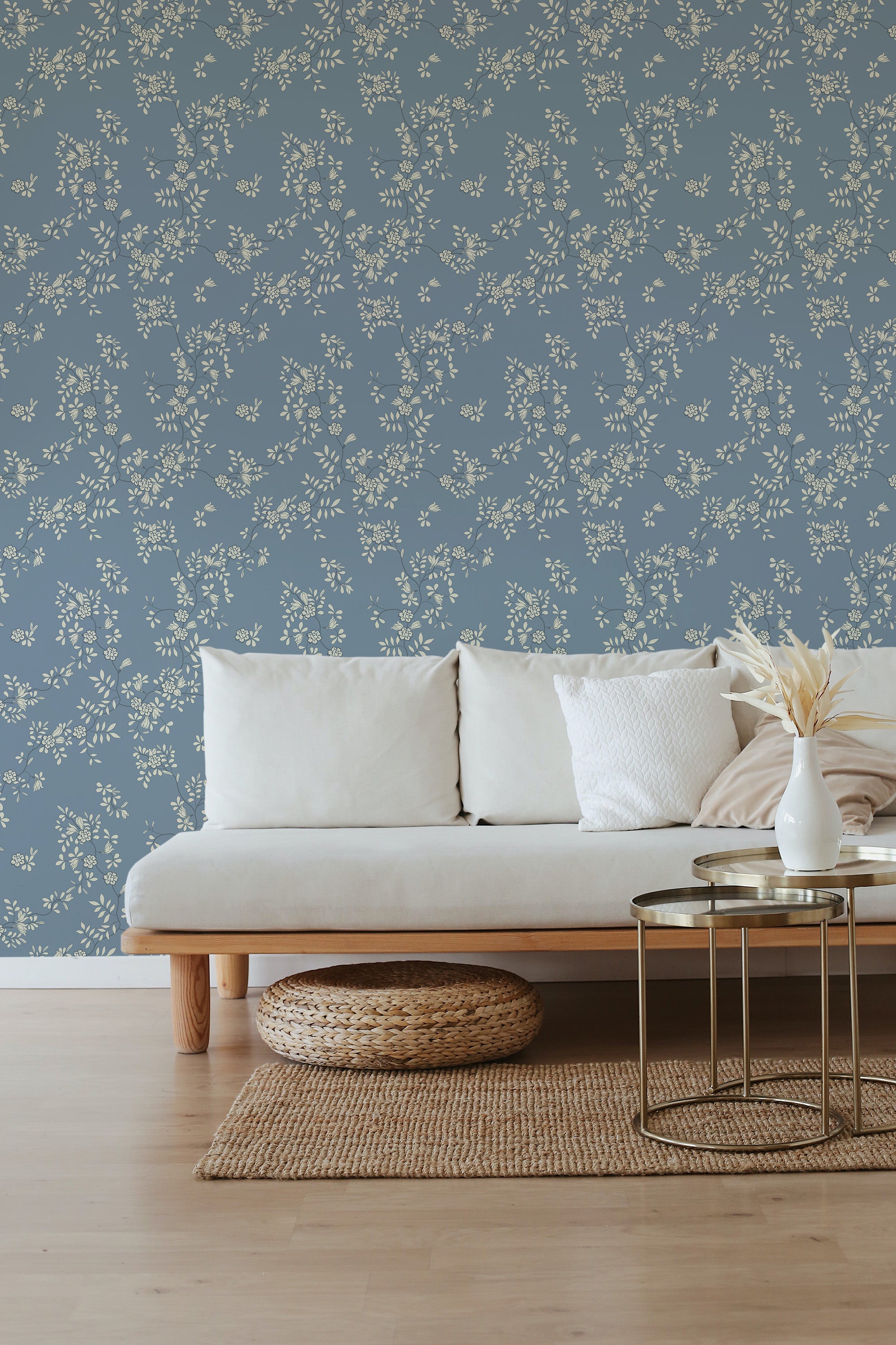 A room with blue wallpaper adorned with delicate white floral patterns, creating a garden-like atmosphere. Traditional wallpaper.