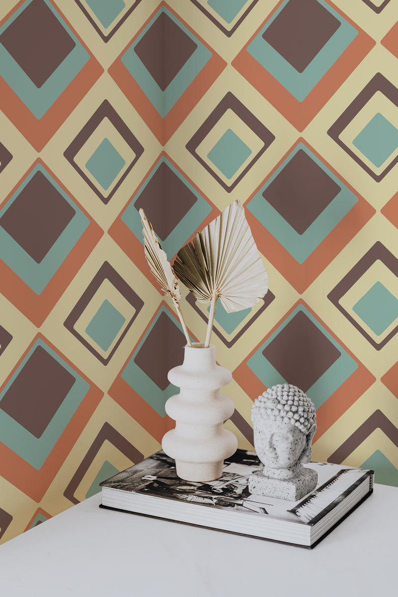 Self-adhesive retro geometric wallpaper with overlapping diamond shapes in a palette of earthy tones, including yellow, brown, orange, mint green, and beige.