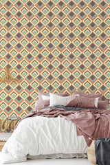 Wallpaper with a retro geometric pattern of interlocking diamond shapes in shades of brown, beige, and light blue, covering the wall behind a bed with cozy linens, creating a warm and nostalgic atmosphere. Traditional wallpaper.