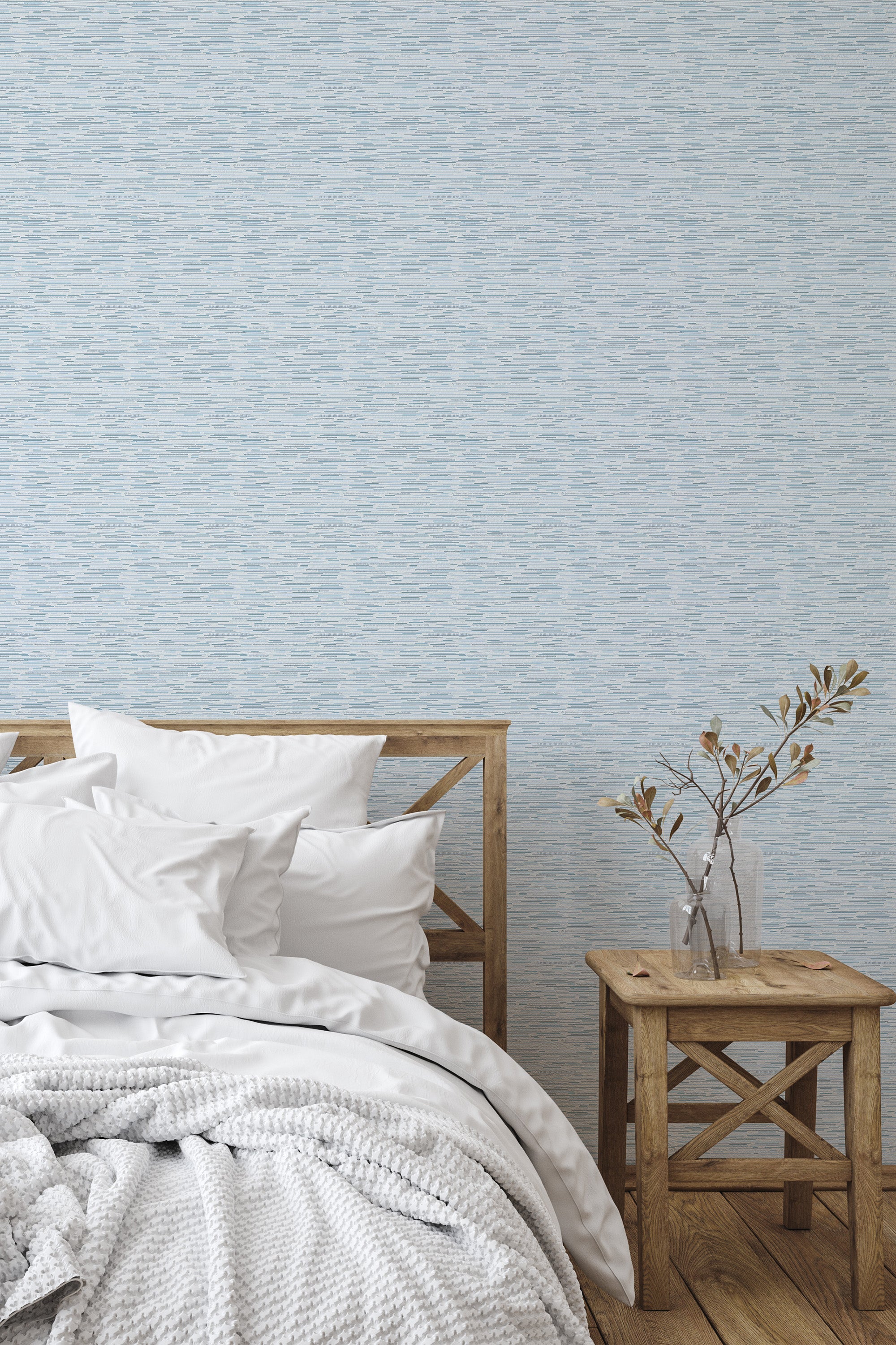 Self-adhesive Grasscloth wallpaper in a subtle blue hue with a textured, woven pattern, paired with neutral bedding and light wood furniture.