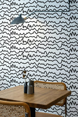 wooden dining table rattan chairs abstract line art peel and stick wallpaper
