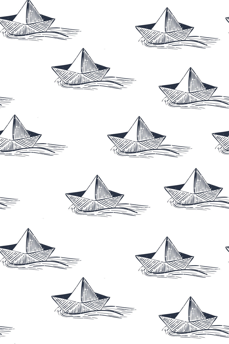 Hand-drawn navy blue paper ships floating on white background, creating a nautical-themed pattern. Peel and stick removable wallpaper.