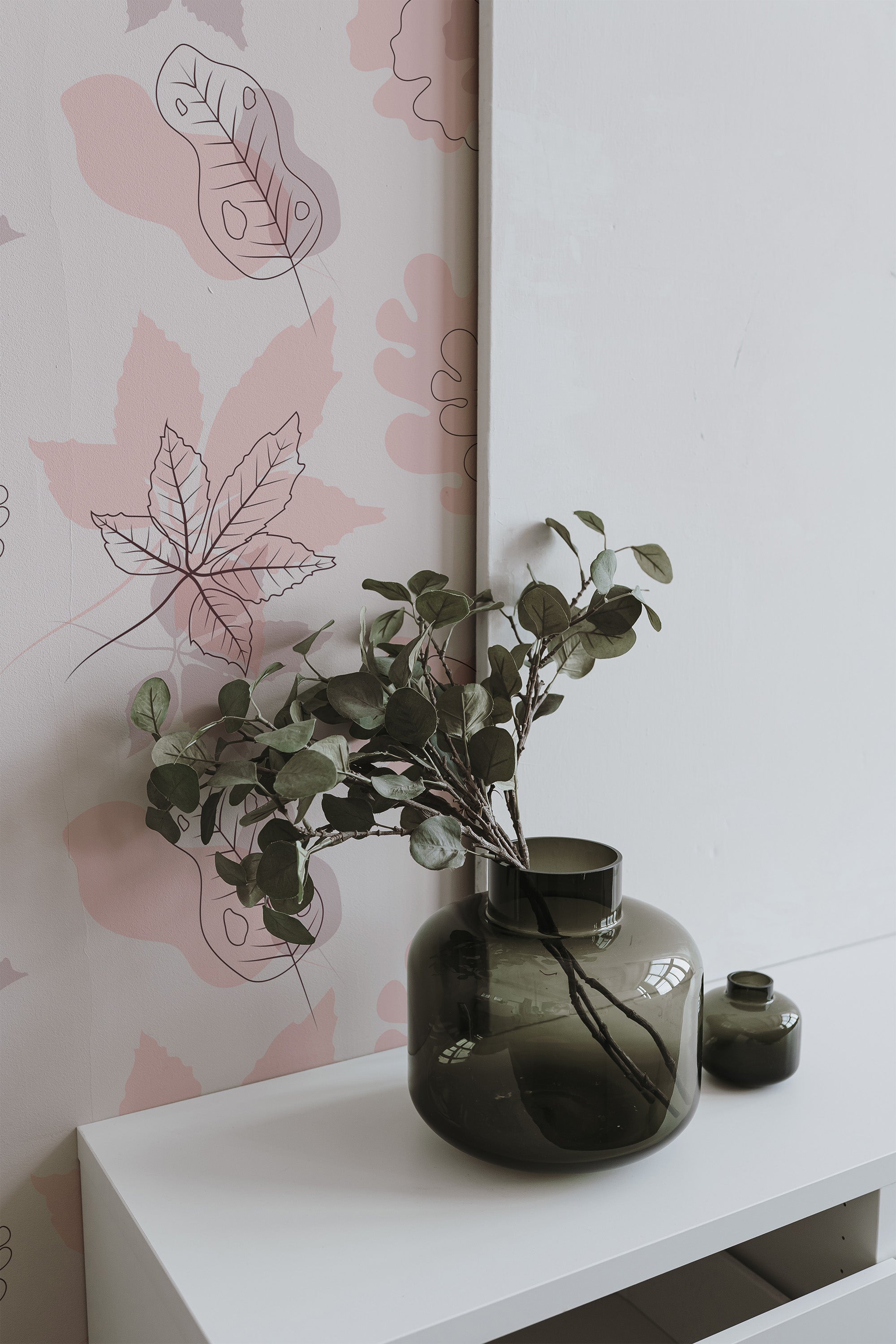 Self-adhesive wallpaper in soft pink tones with an autumn theme, incorporating delicate leaves and abstract shapes in varying shades of pink and gray.