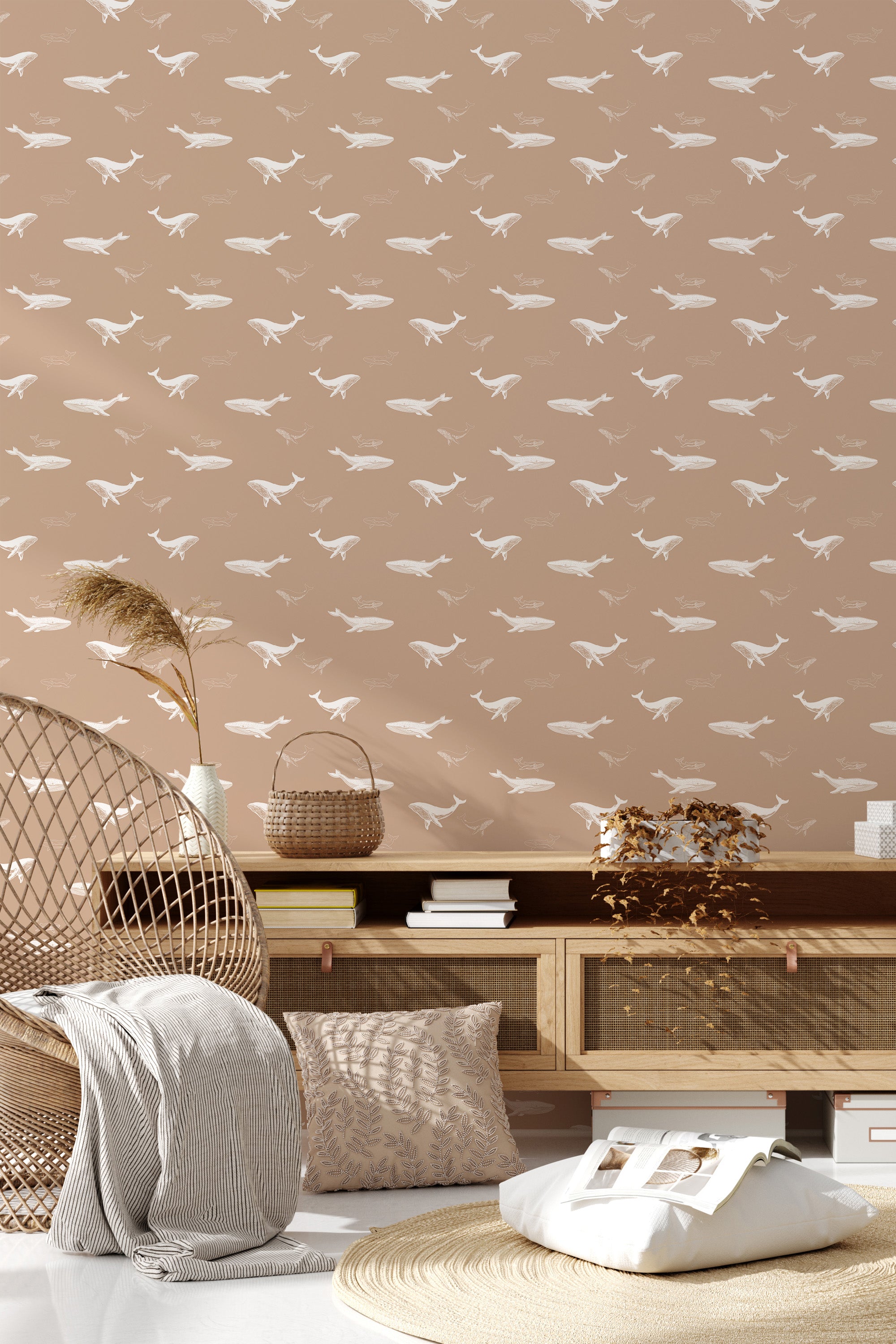 This wallpaper design has a soft beige background with repeat white whale silhouettes swimming in different directions, creating a serene and playful ocean-themed pattern. Traditional wallpaper.