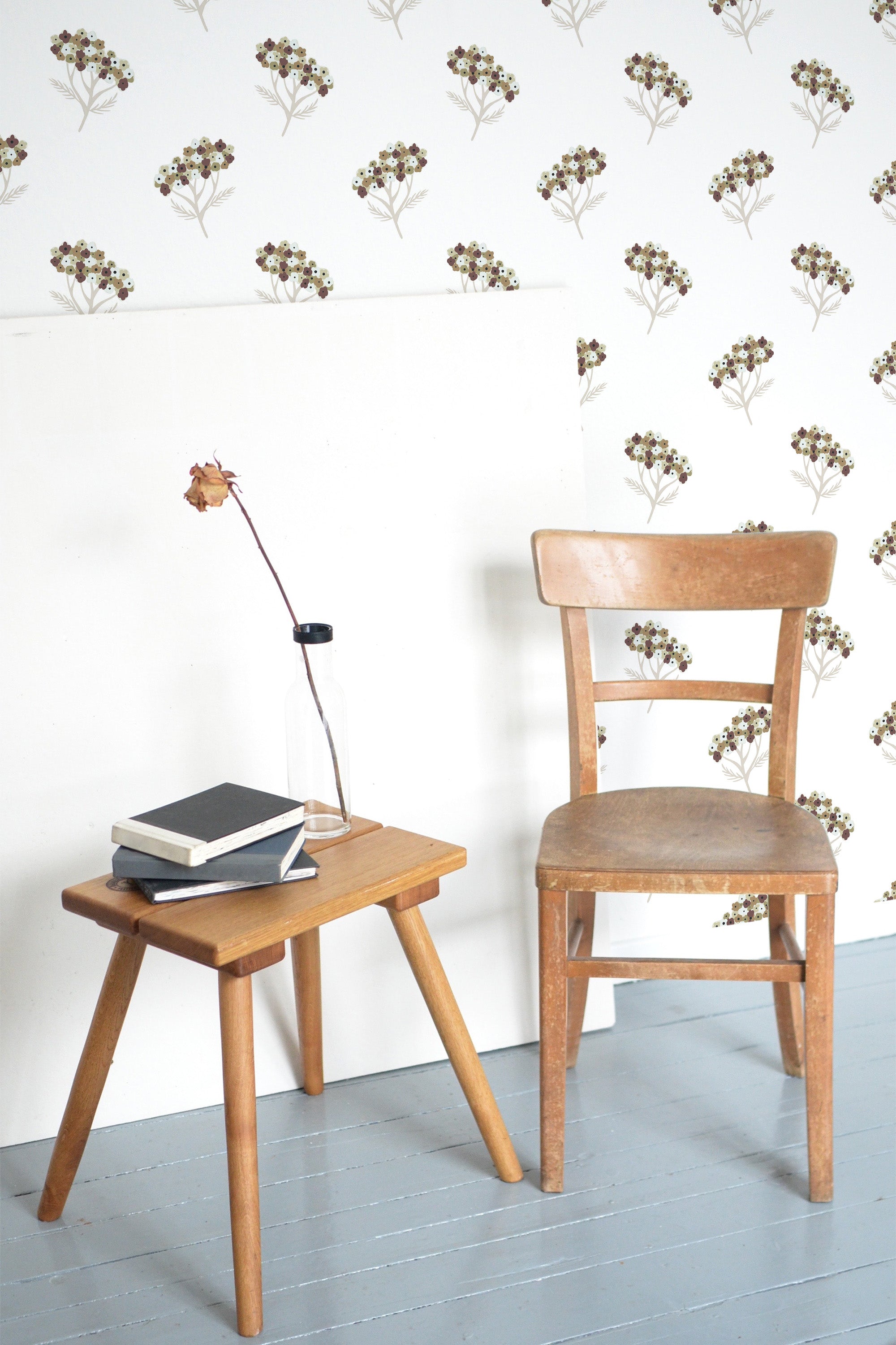 Self-adhesive wallpaper with a Yarrow design in muted tones of brown, green, and beige on a white background, creating a subtle, nature-inspired pattern.