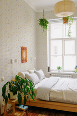 Self-adhesive wallpaper with a geometric tile design in soft pastel colors, adding a modern and subtle touch to the room's decor.