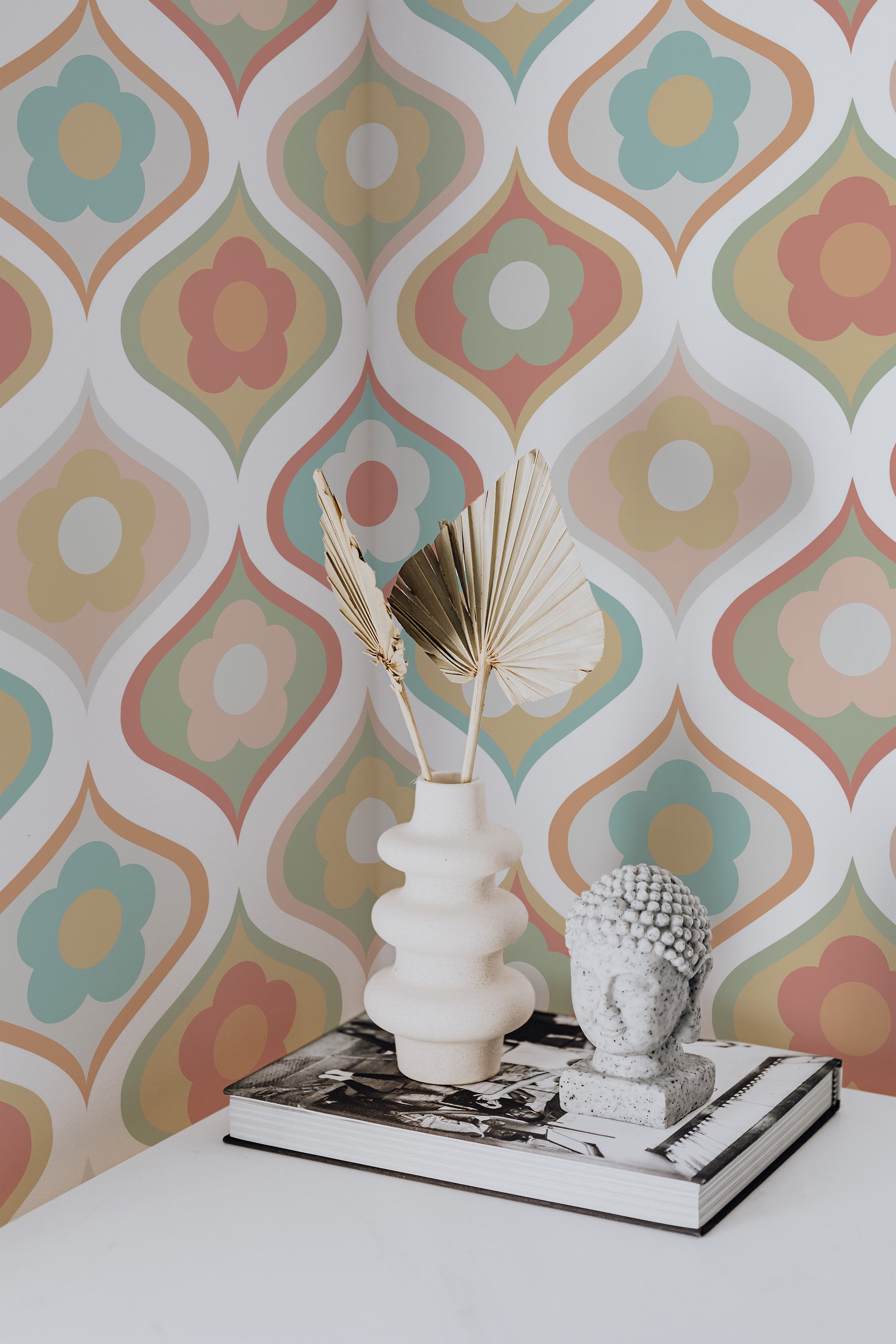 Self-adhesive wallpaper with pastel retro flowers in a geometric pattern, featuring soft hues of orange, teal, pink, and yellow against a white background.