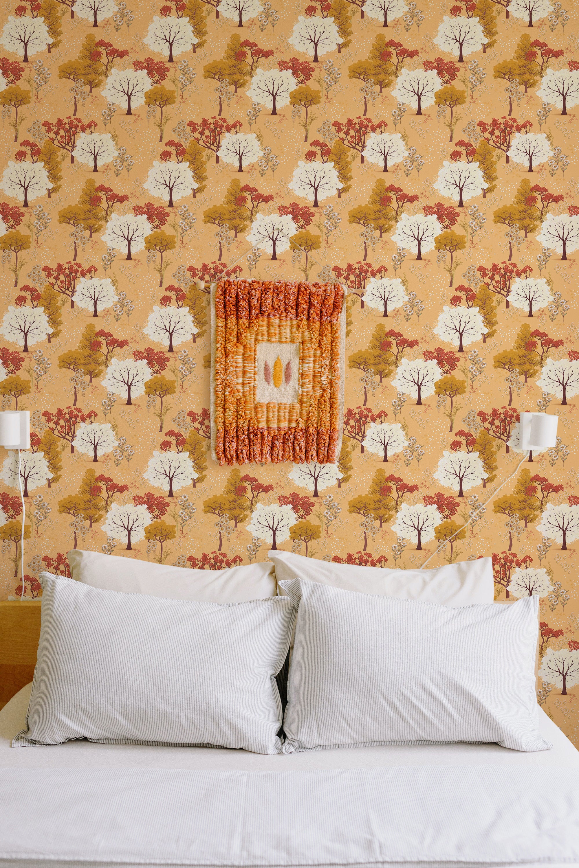 Self-adhesive wallpaper with a Magical Forest design with trees in warm shades of orange, yellow, and red. The pattern exudes an autumnal vibe, with scattered foliage creating a cozy, natural aesthetic.