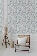 Wallpaper with a delicate botanical pattern of spring birds, leafy branches, and soft flowers in muted green, pink, and blue tones on a light background, creating a serene atmosphere. Traditional wallpaper.