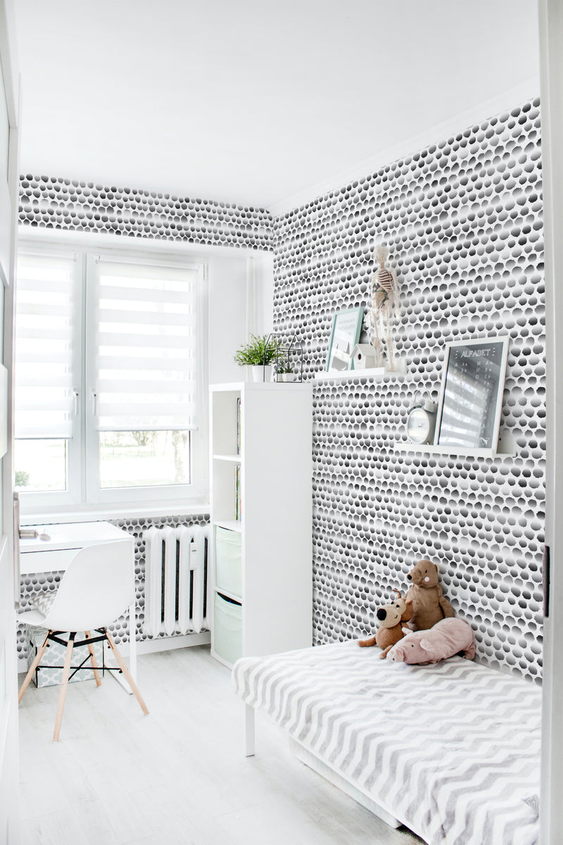 A room with wallpaper in a pattern of small, evenly spaced black dots on a white background, creating a repeating design that resembles a field of moons. The wallpaper covers the entire wall, from floor to ceiling, giving the room an elegant and cohesive look. Traditional wallpaper.