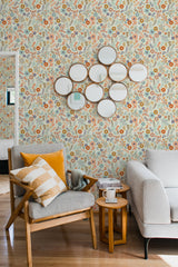 Yellow floral wallpaper with intricate patterns of flowers and leaves in hues of orange, pink, and green, creating a vibrant and lively backdrop. Traditional wallpaper.