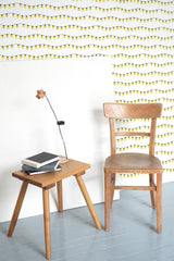 Self-adhesive wallpaper with a festive design of yellow Christmas lights strung in a wavy pattern across a white background.