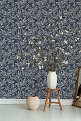 Self-adhesive wallpaper with a navy background and intricate white leaf patterns, creating an elegant botanical theme in the room.