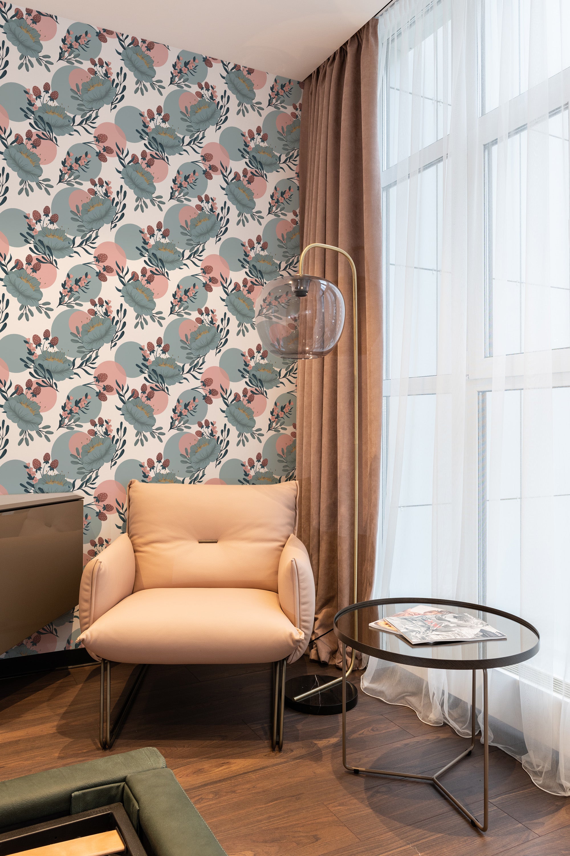 A cozy room with a wall adorned in a pastel boho floral wallpaper with soft pinks, muted greens, and detailed botanical patterns. The design captures a delicate balance between modern and vintage aesthetics, creating a serene and elegant atmosphere. The wallpaper complements the warm tones of the room, enhancing the calming and inviting feel. The room also has floor-to-ceiling windows and luxurious curtains. Traditional wallpaper.