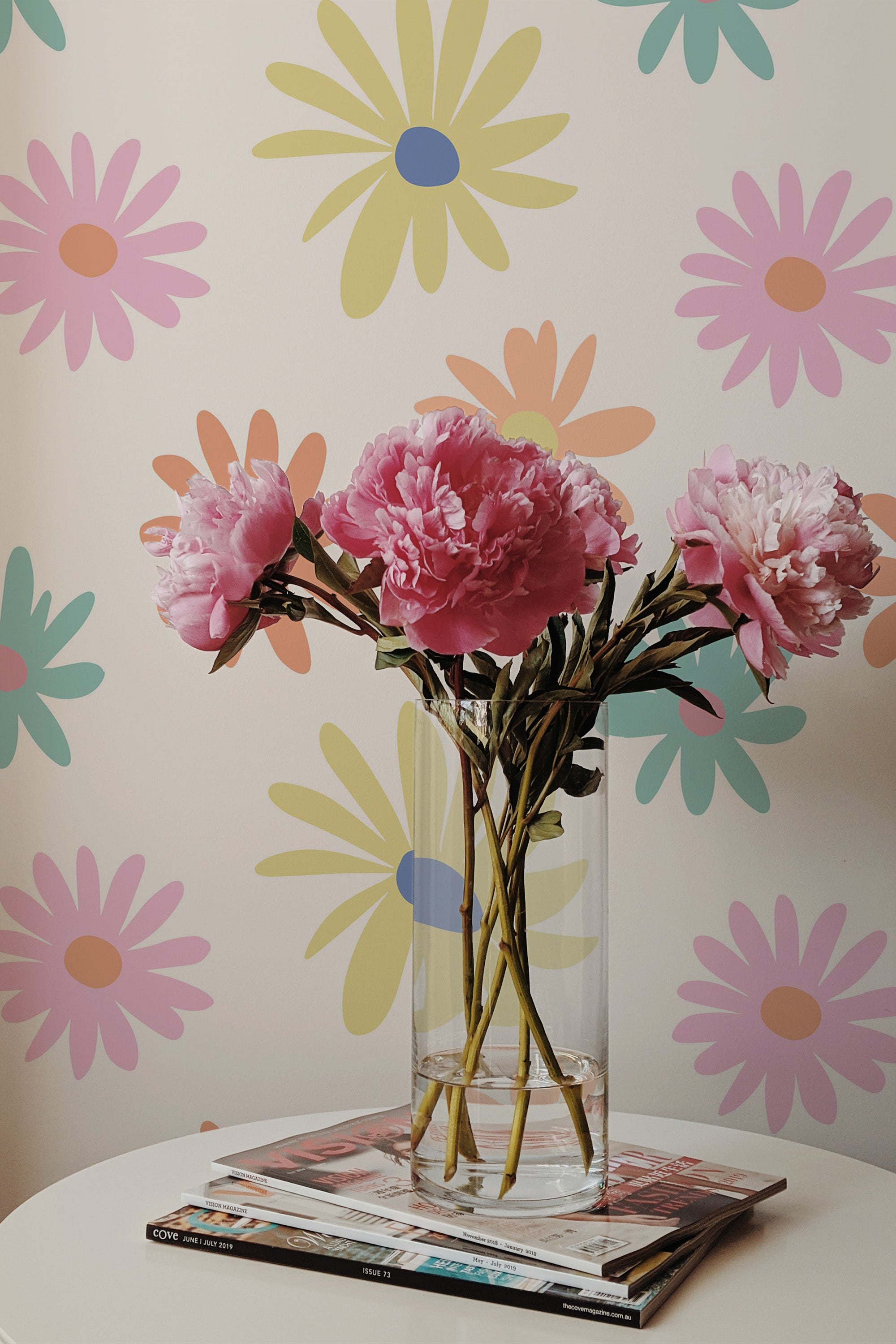 Self-adhesive wallpaper with a colorful retro floral design, featuring pastel-toned flowers in shades of yellow, pink, orange, and mint green, creating a cheerful and vibrant backdrop.
