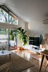 minimalist house terrace green plants living room neutral bow stripe stick and peel wallpaper
