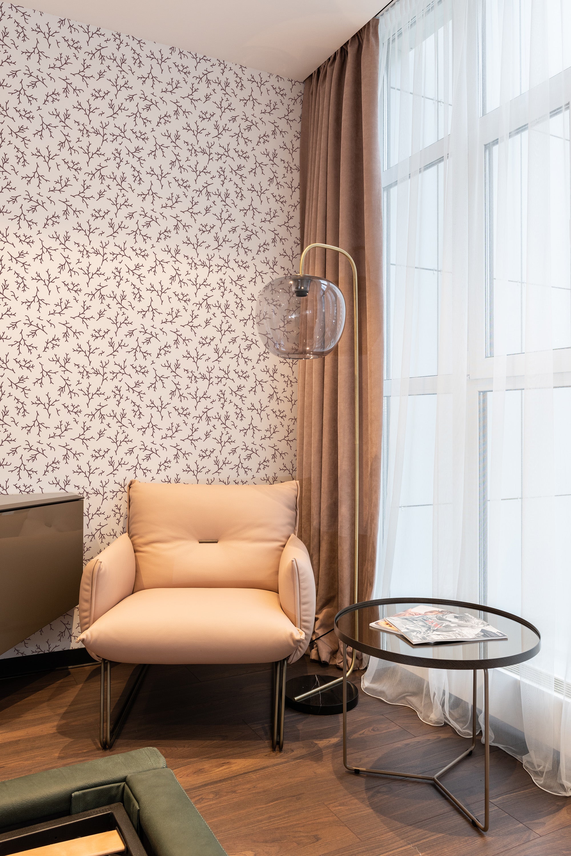 An elegant room with Burgundy Branch wallpaper, accented with delicate, intertwining branches and small leaves set against a light background. Traditional wallpaper.