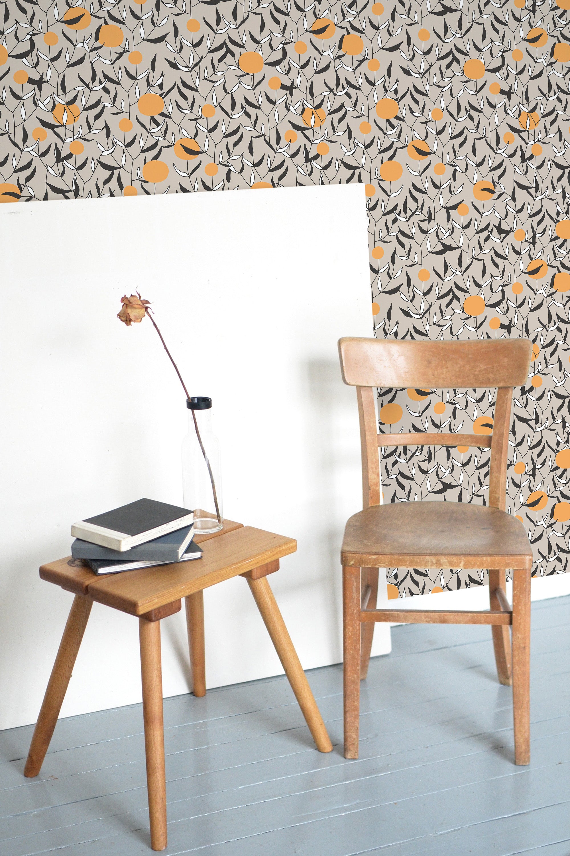 Self-adhesive wallpaper with a Neutral Orange Tree design showing stylized orange fruits and delicate black branches on a light background, adding a touch of nature-inspired elegance to the room.