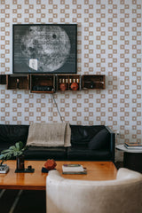 Wall adorned with a neutral striped squares design in soft beige and white, creating a balanced geometric patterned traditional wallpaper.