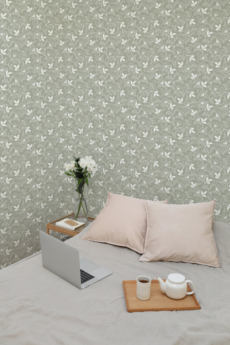 Self-adhesive vintage flowers wallpaper with a subtle green background and intricate white floral patterns, adding a touch of elegance and nostalgia to the room.
