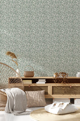 The wallpaper has a design with subtle green leaves arranged in a neat, dense pattern, creating a natural, Scandinavian-inspired look. Traditional wallpaper.