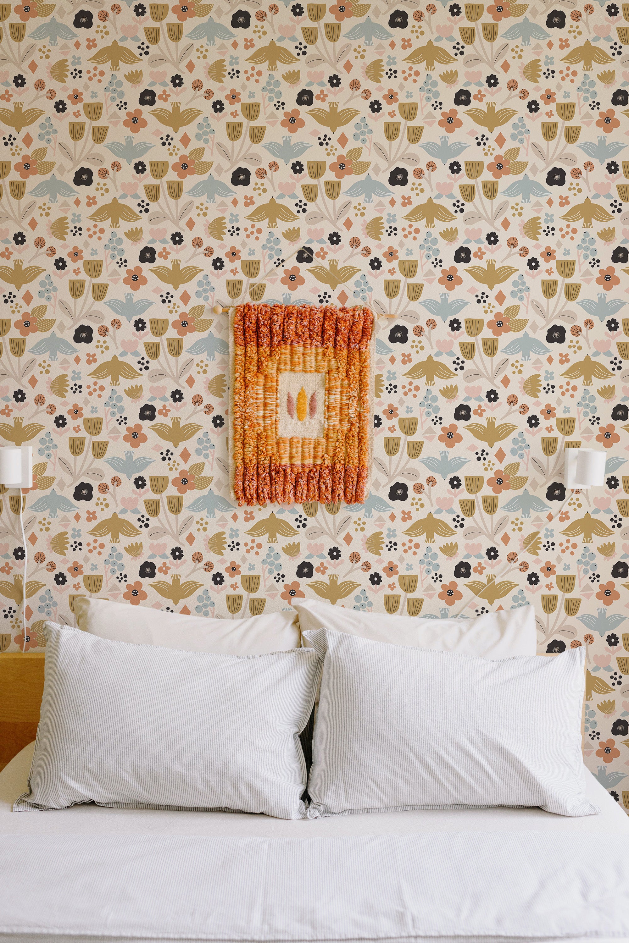 Self-adhesive wallpaper with a Fun Scandinavian bird design of stylized birds, flowers, and leaves in soft, muted tones of beige, green, blue, and pops of orange, adding a playful, nature-inspired vibe to the room.