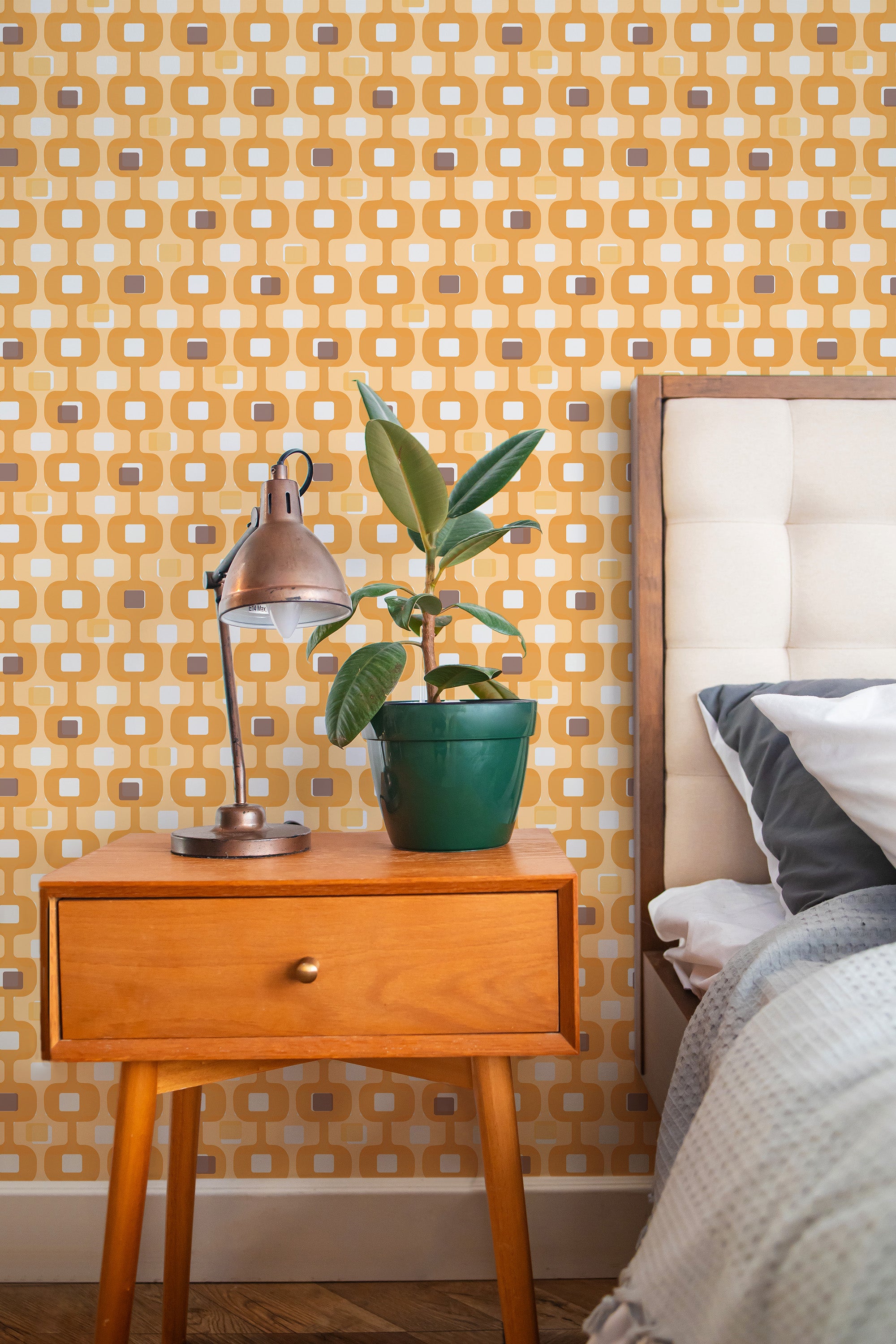 Self-adhesive yellow mid-century wallpaper with a geometric pattern of interlocking squares and rounded rectangles in shades of mustard, brown, and white.