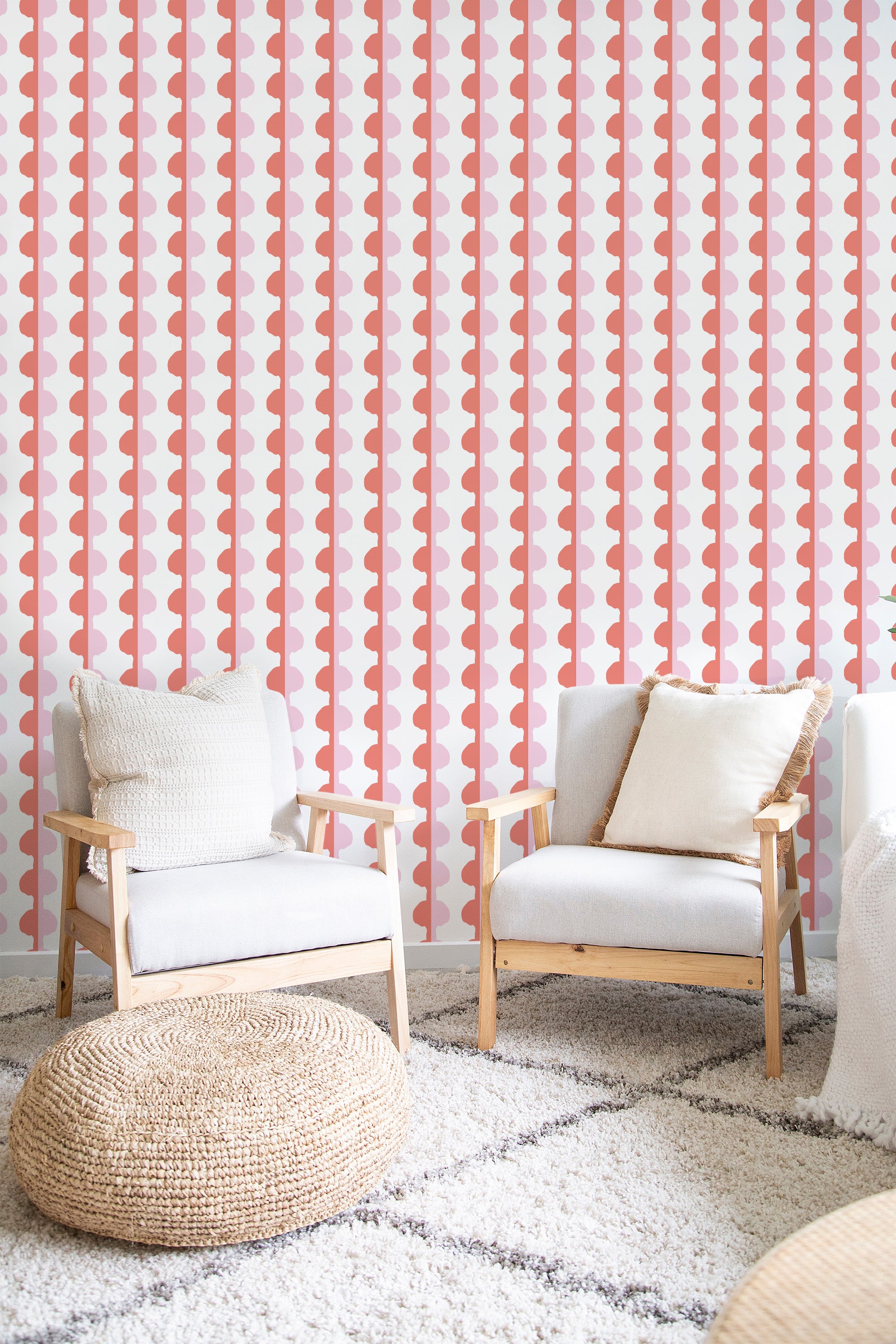 A room with a wall covered in Pink eclectic stripe wallpaper, characterized by vertical stripes in shades of pink, ochre, and white, with shapes that alternately resemble hearts or leaves. A bright and bold design that adds a modern twist to traditional wallpaper.