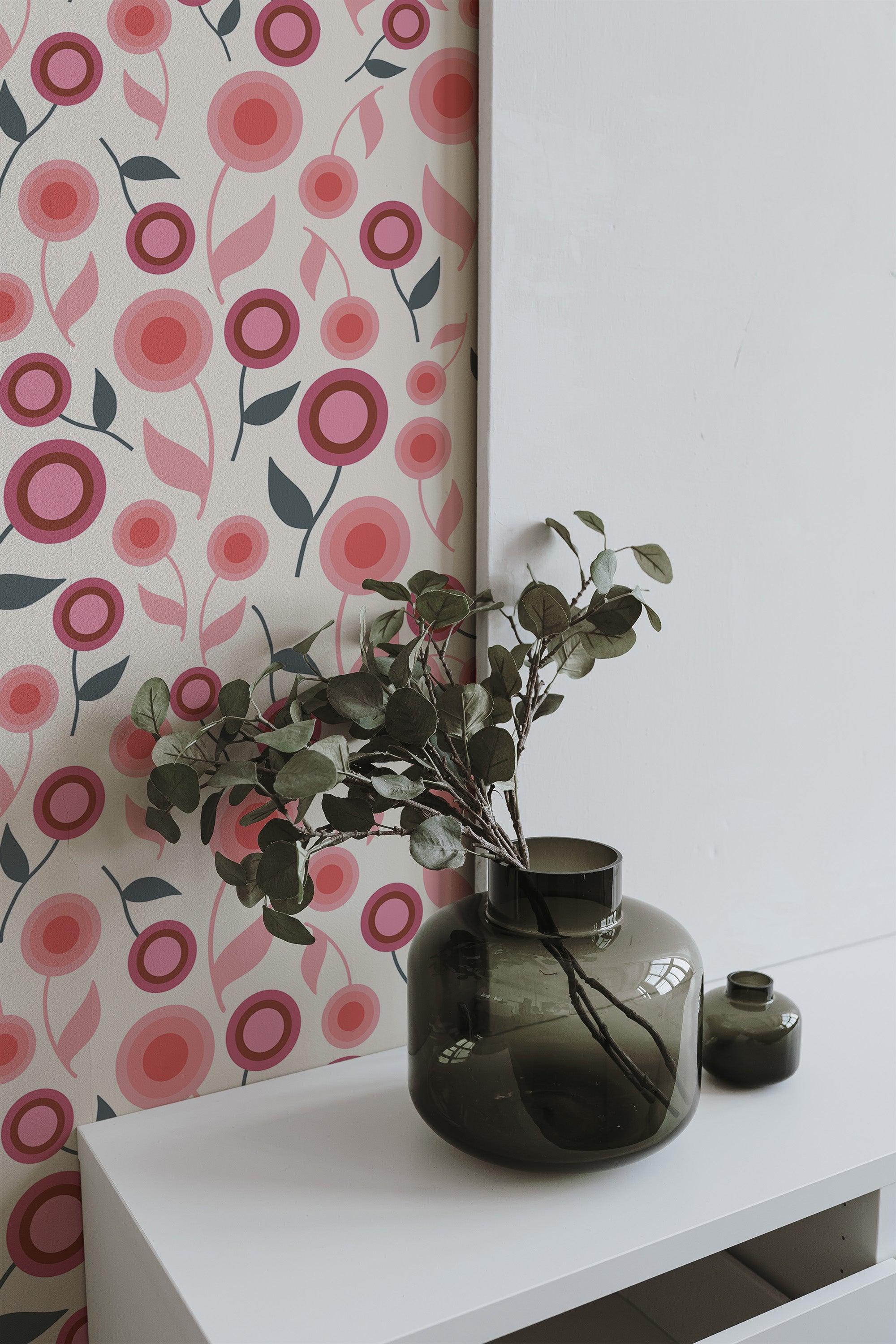 Self-adhesive wallpaper with a playful design of pink and red stylized flowers and green stems on a light beige background.