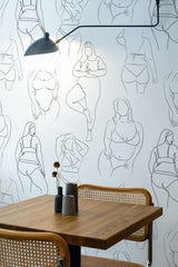 Self-adhesive wallpaper with minimalist black line art of diverse female figures in various poses, celebrating body positivity against a neutral background.