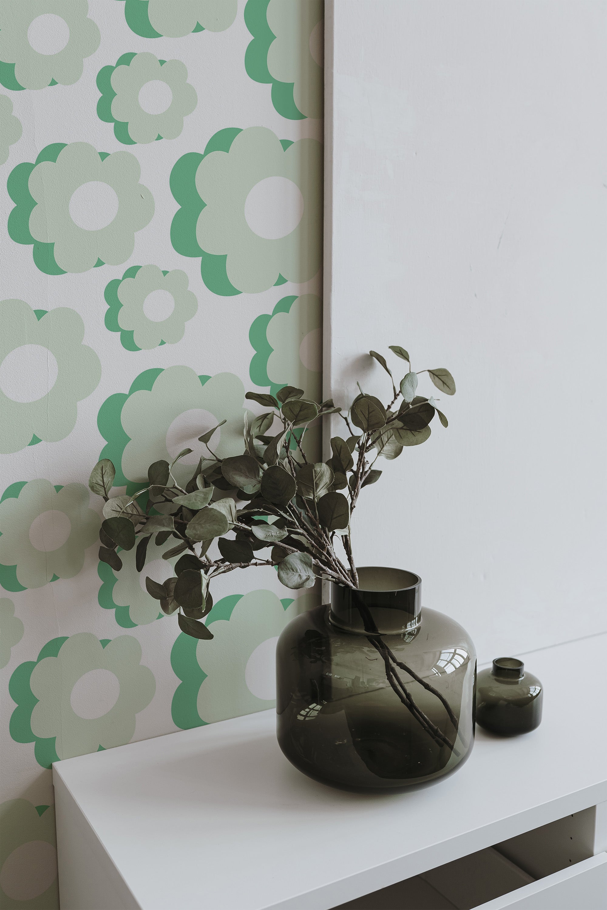 Self-adhesive wallpaper with a Green retro flower pattern featuring oversized, stylized flowers in various shades of green and white, creating a vintage, mid-century vibe.