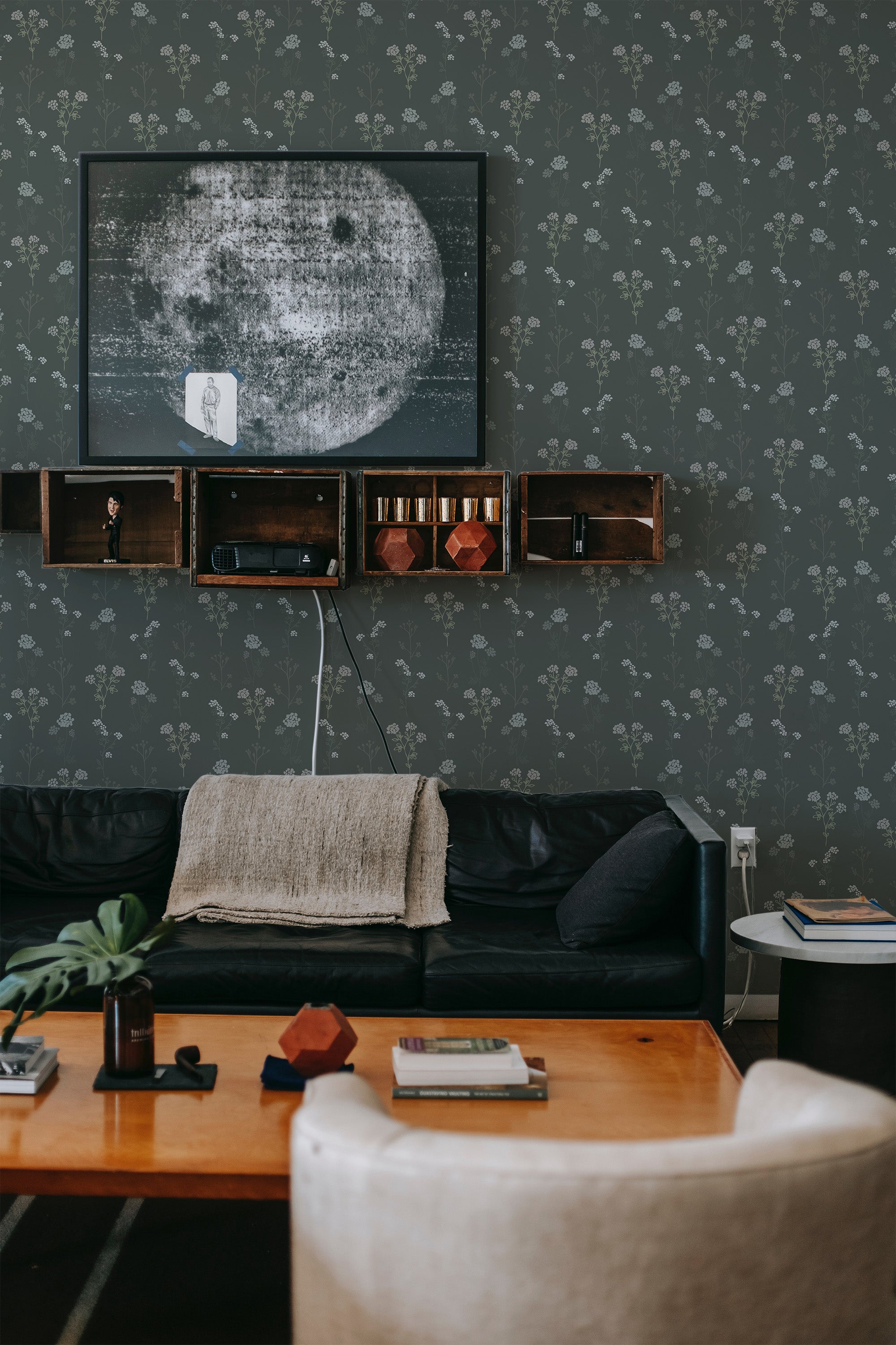 Dark green scandinavian wallpaper with subtle, light-colored floral patterns creating a calm and cozy atmosphere in the room. Traditional wallpaper.