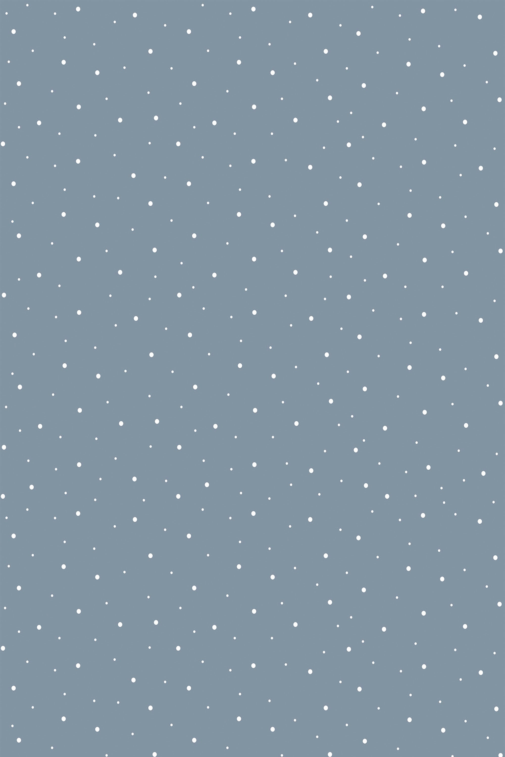 Blue wallpaper with scattered white dots in various sizes, creating a subtle textured look for a calm, beach-inspired space. Peel and stick removable wallpaper.