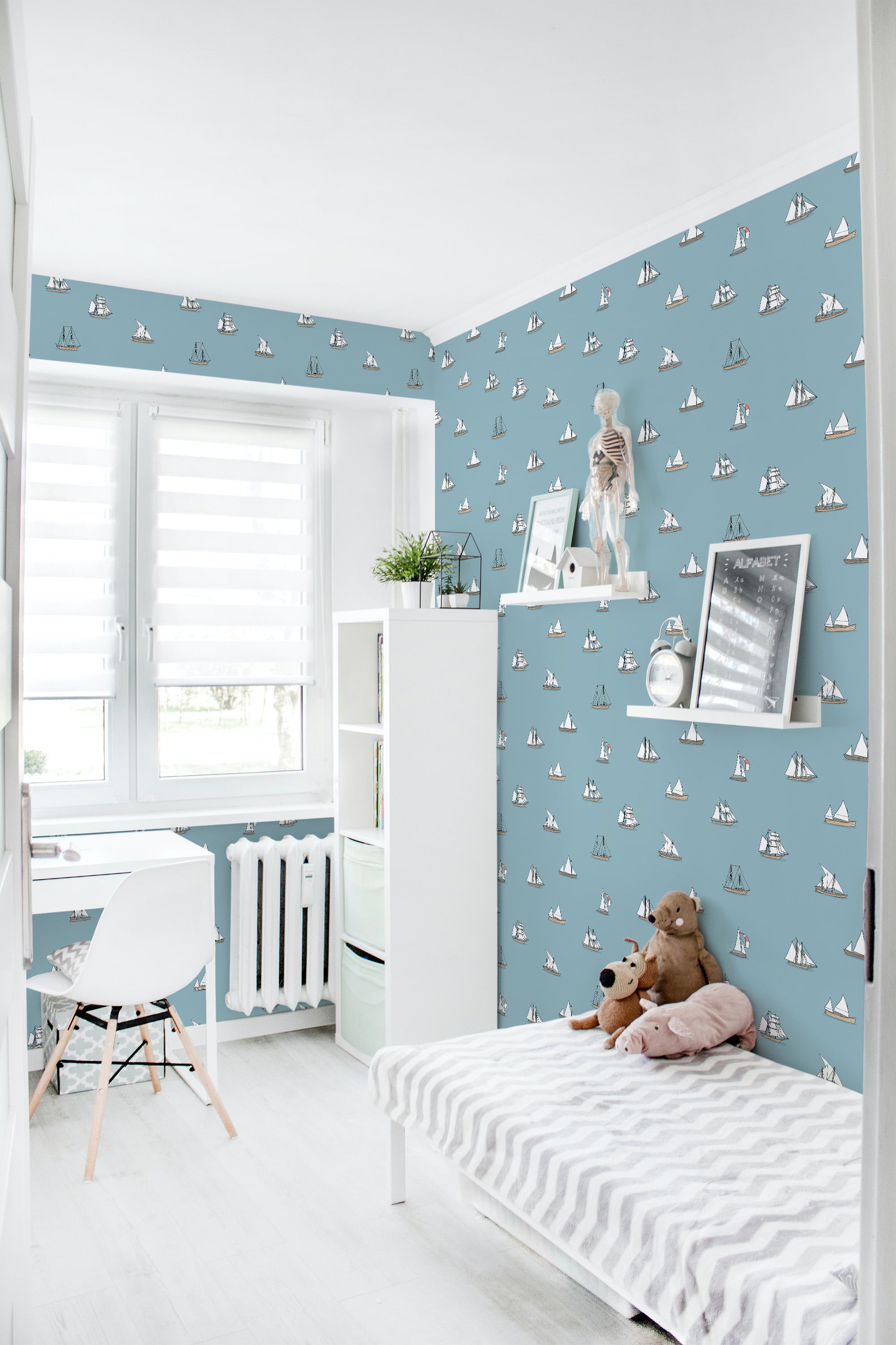 Room with a blue wallpaper pattern of small white sailboats scattered uniformly across the walls, giving the space a nautical-themed ambiance. The wallpaper adds a classic and serene touch to the room, complemented by white furniture and soft decor elements. Traditional wallpaper.