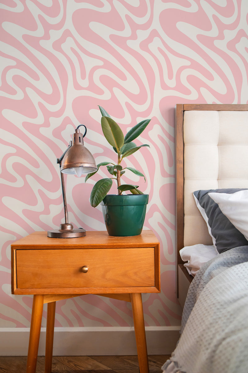 Self-adhesive wallpaper with a pink funky wave design composed of abstract, flowing shapes in soft variations of pink and white, creating a lively and modern look.