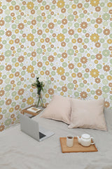 Self-adhesive wallpaper with a Neutral flower meadow design. A pattern of flowers in soft hues of beige, yellow, green, and white covers the wall, creating a calm and cozy atmosphere in the room.