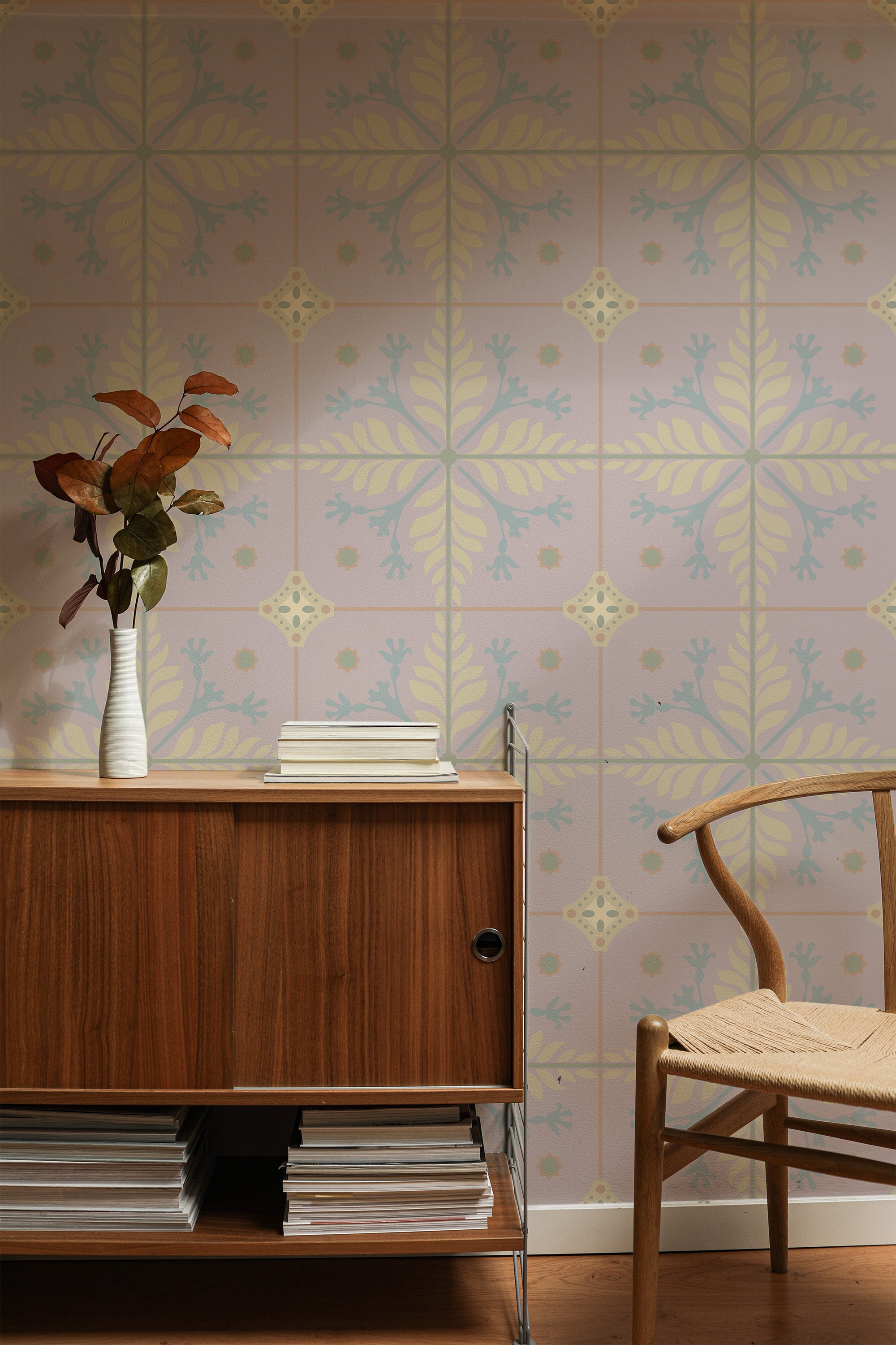 Self-adhesive wallpaper with a Pink floral tile pattern, featuring delicate leaf motifs and symmetrical designs in soft pastel shades, adorning a modern living space with a mid-century modern wooden cabinet and a chair.