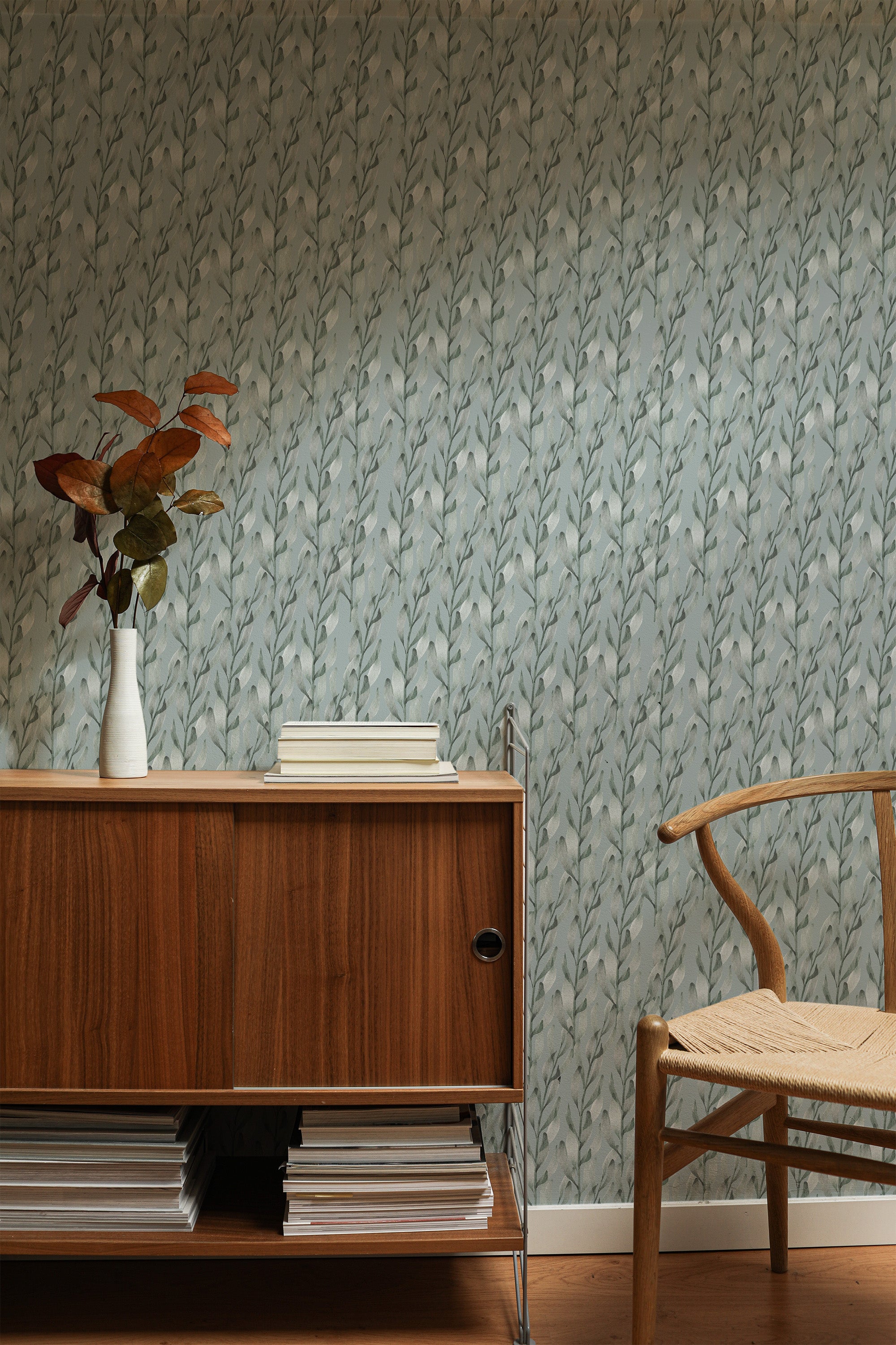 Self-adhesive wallpaper with a watercolor leaves design, characterized by soft, leafy patterns in varying shades of green against a muted, light-toned background.
