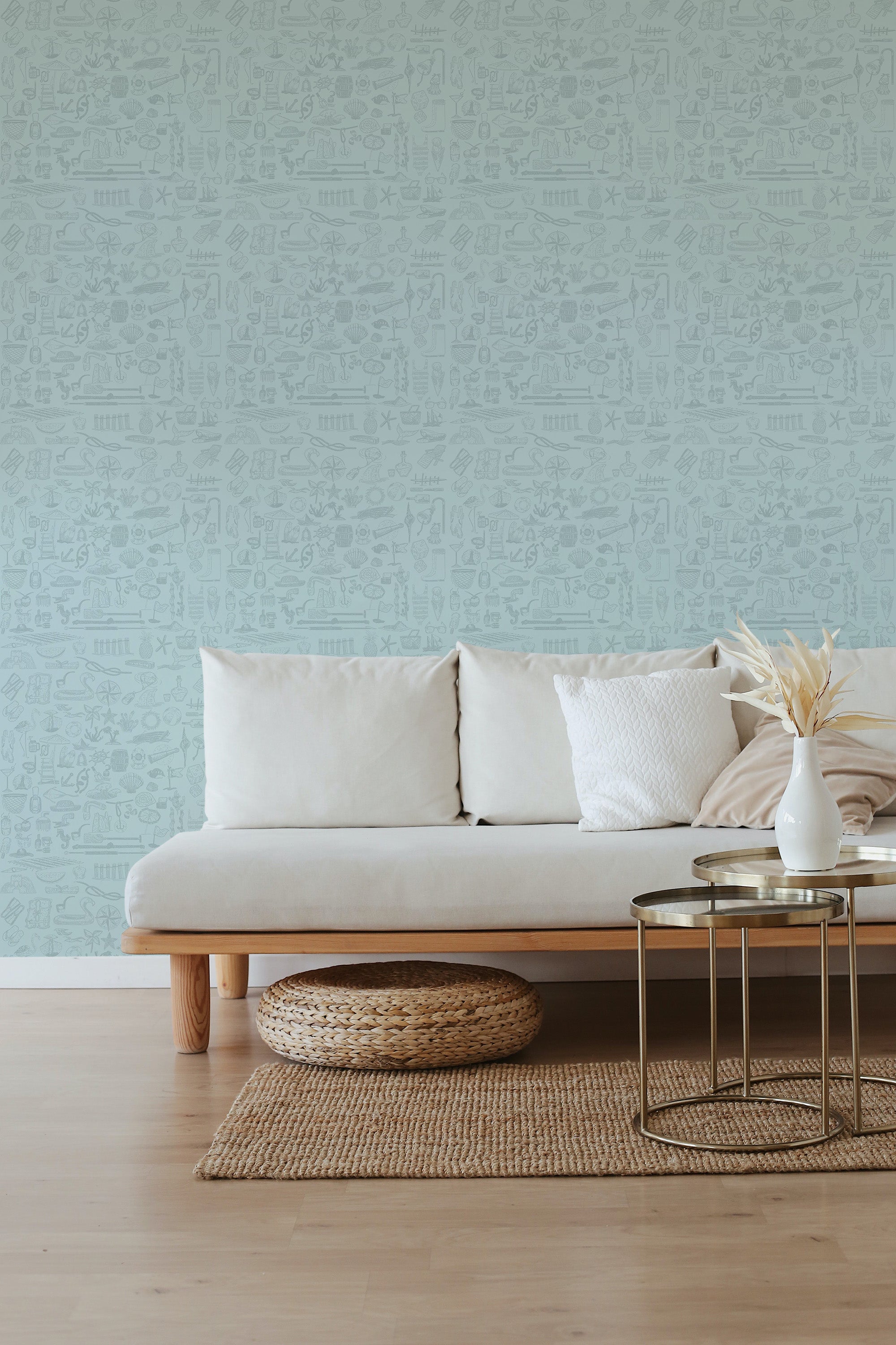 Coastal elements wallpaper in a soft blue-green hue with intricate, small-scale patterns of seashells, corals, and marine life, creating a serene and breezy atmosphere in the room,raditional wallpaper.