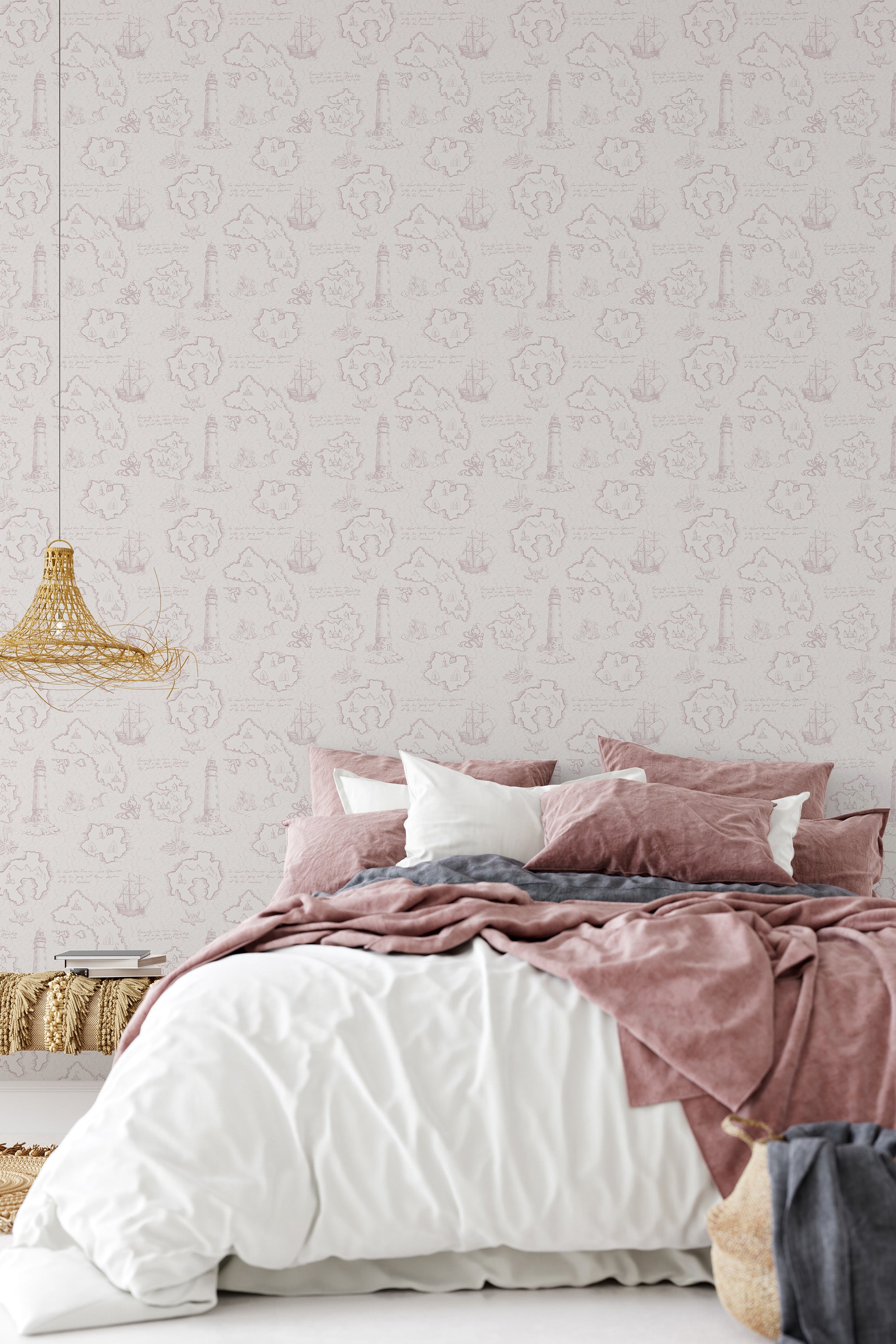Wallpaper with a light pink design of sea maps, including intricate patterns of compasses, ships, and anchors, on a white background behind a bed. Traditional wallpaper.