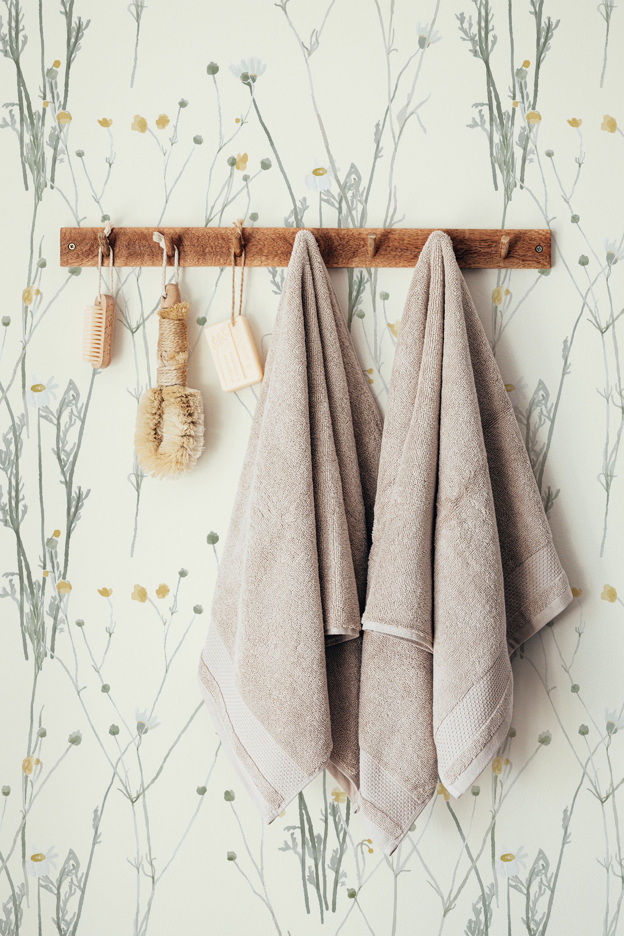 Self-adhesive wallpaper with a minimal wildflower design including delicate, hand-drawn botanical elements in muted tones of green, yellow, and gray, creating a subtle and naturalistic aesthetic.