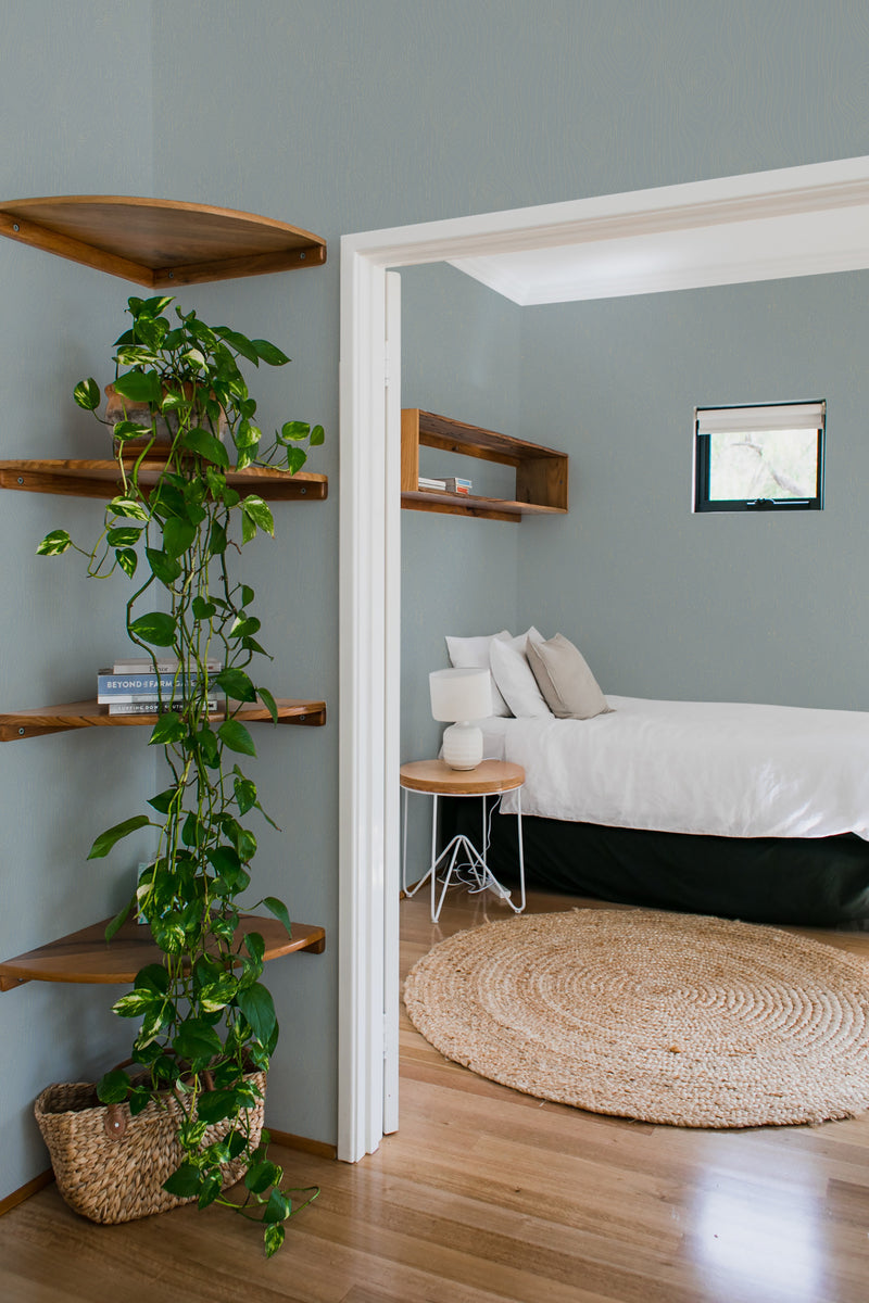 bedroom cozy interior green plants round carpet gray wood wall peel & stick wallpaper