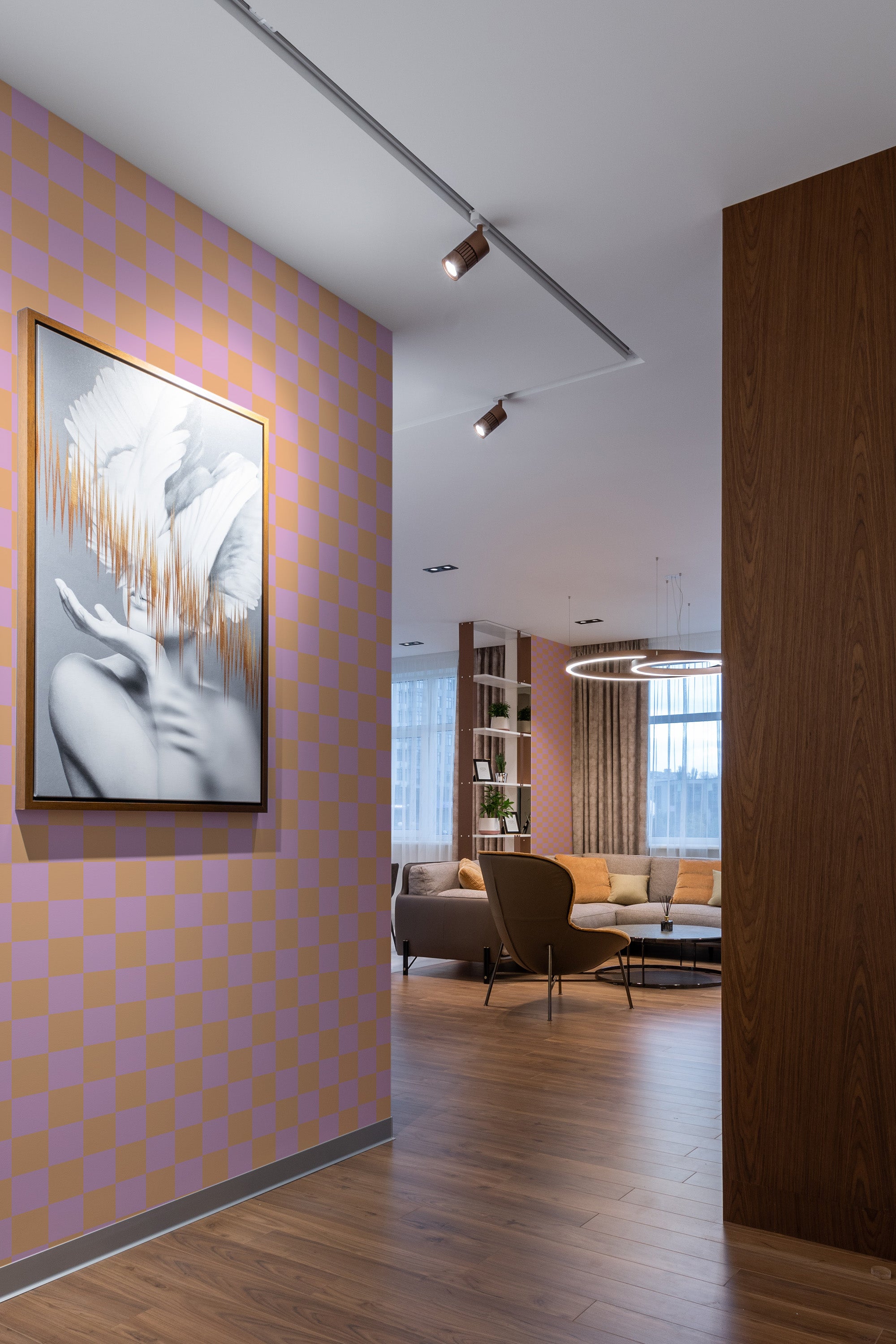 A wall covered with pink and orange checkered wallpaper in a traditional wallpaper style.