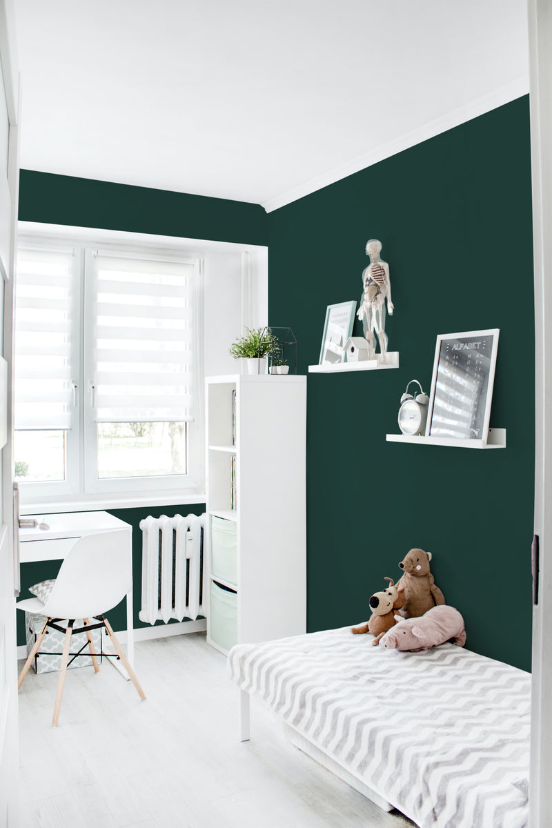A room with Forest green solid wallpaper on the wall, bringing a rich and deep green tone to the space. The wallpaper adds a bold yet calming atmosphere and pairs well with the white furniture and decor, creating a cozy and harmonious environment. Traditional wallpaper.