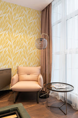 wallpaper stick and peel yellow leaves pattern modern armchair lamp table reading area