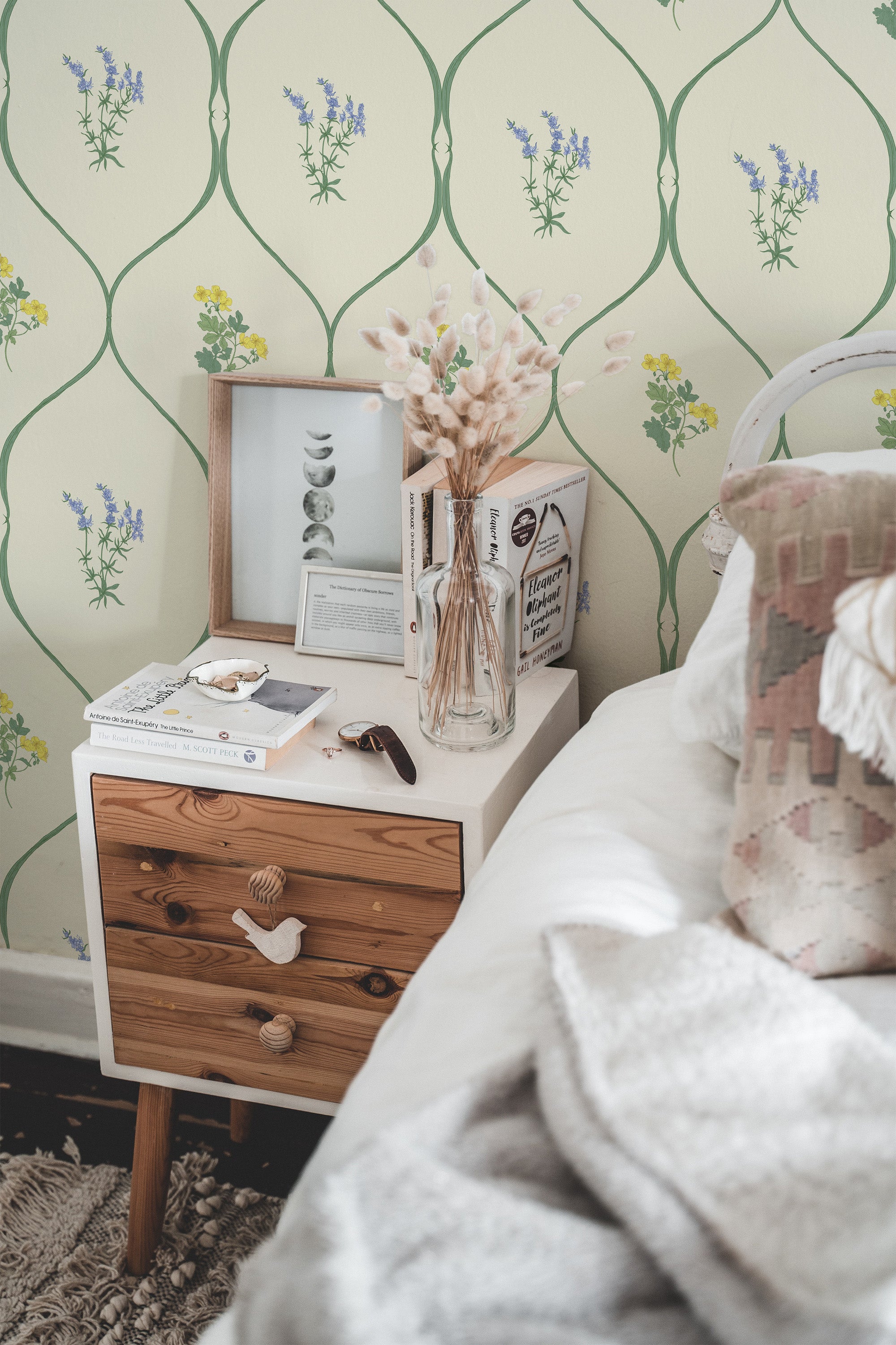 Self-adhesive wallpaper with a vintage summer meadow design, featuring delicate floral patterns in soft shades of yellow, green, and lavender on a cream background, complementing the cozy and serene bedroom setting.