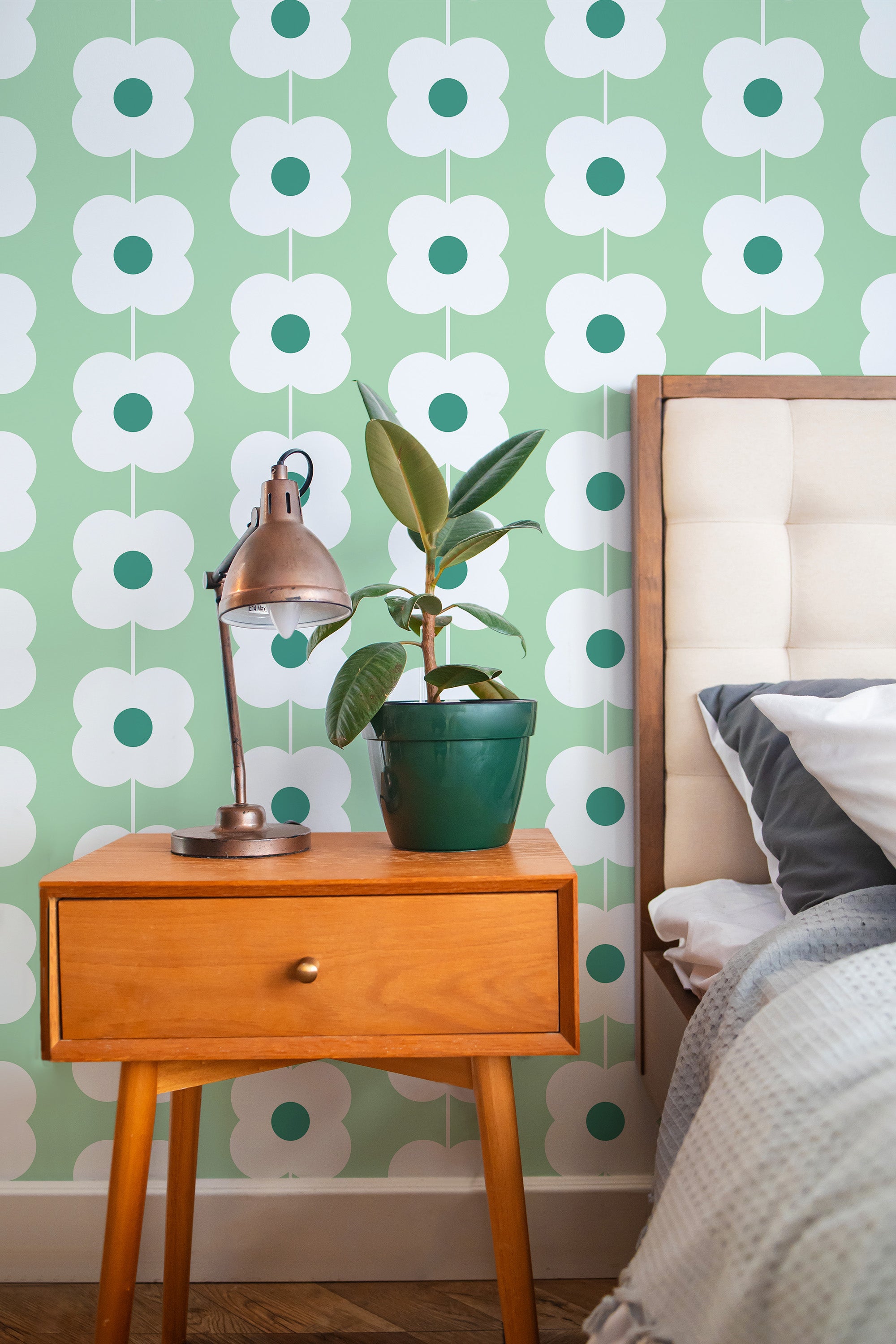 Self-adhesive wallpaper with a green retro floral line design, repeating bold white flowers with dark green centers on a light green background, creating a vintage aesthetic.