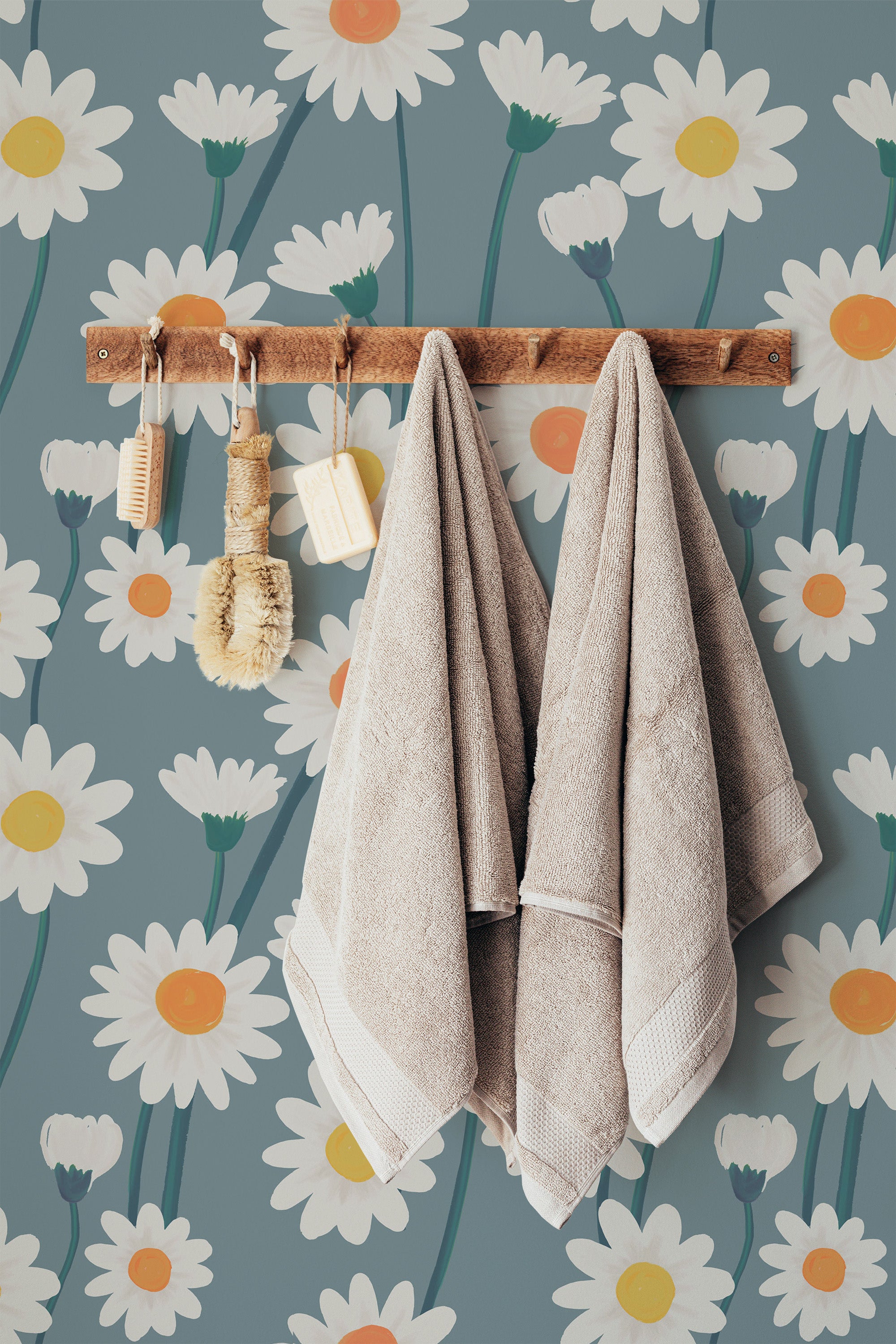Self-adhesive wallpaper with a Daisy field design, showing large white daisies with yellow centers and green stems on a muted teal background.