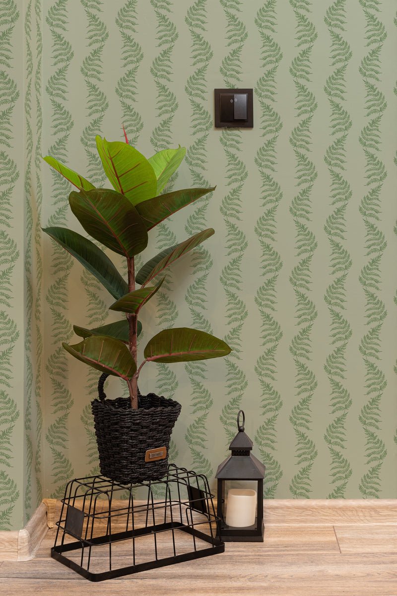 Self-adhesive wallpaper with a green fern pattern on a light green background, giving a natural and fresh feel to the room.